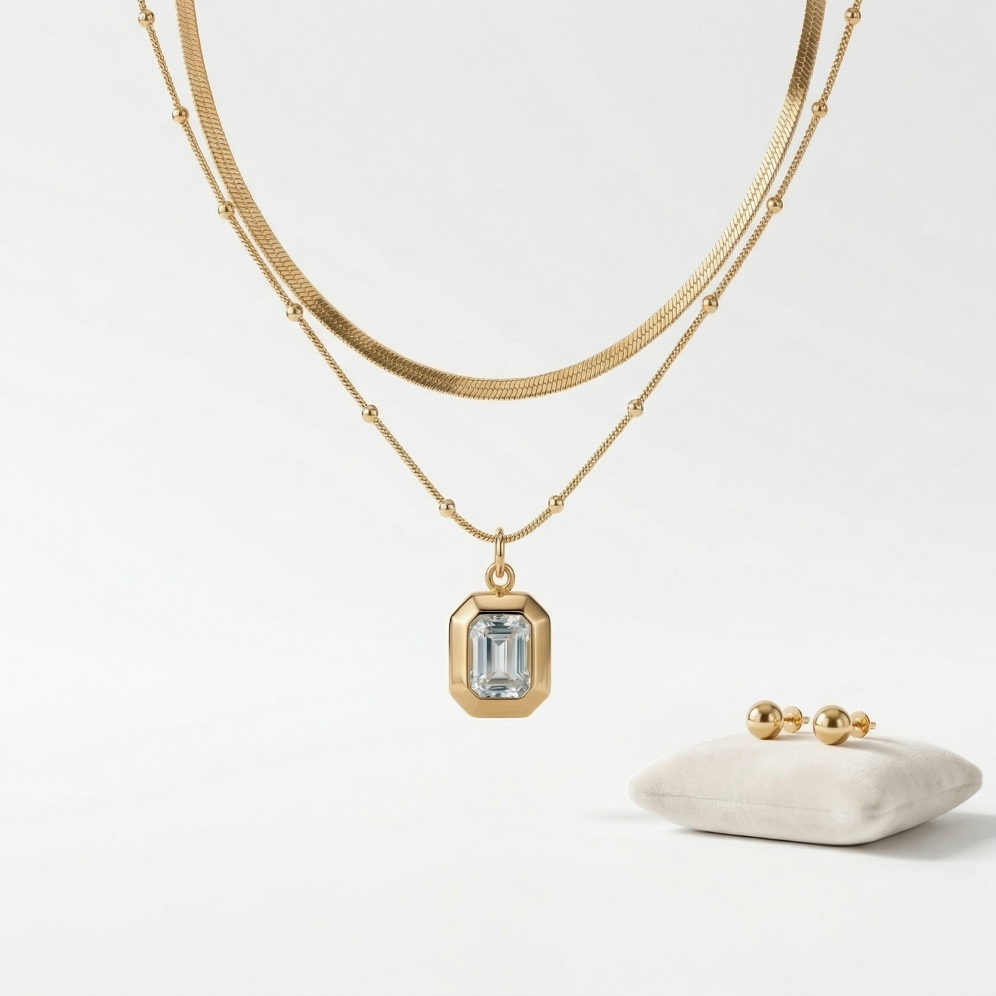 Gold necklace with a pendant on a white background