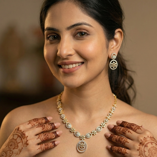 Woman wearing a necklace with henna designs on her hands and shoulders.
