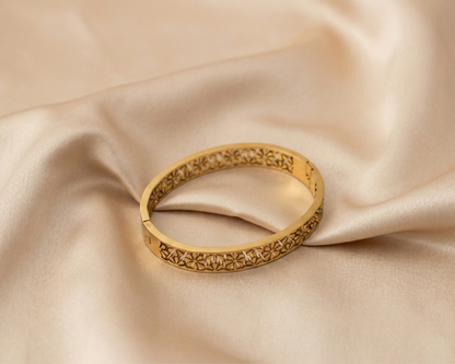 Gold bracelet on beige fabric