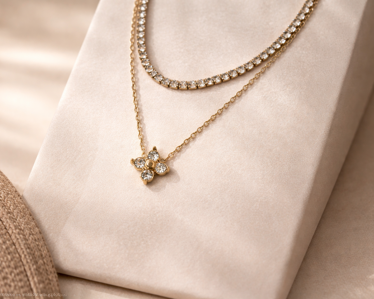 Gold necklace with a star-shaped pendant on a soft beige background