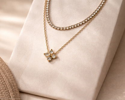 Gold necklace with a star-shaped pendant on a soft beige background