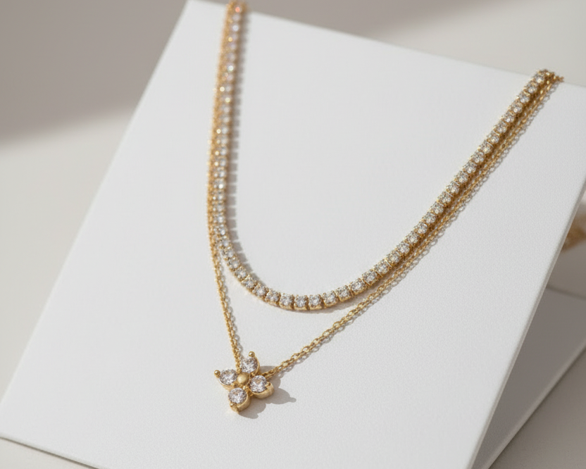 Gold necklace with a pendant on a light gray card