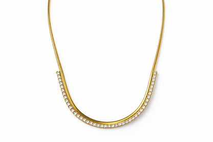 Gold necklace with embedded stones on a white background