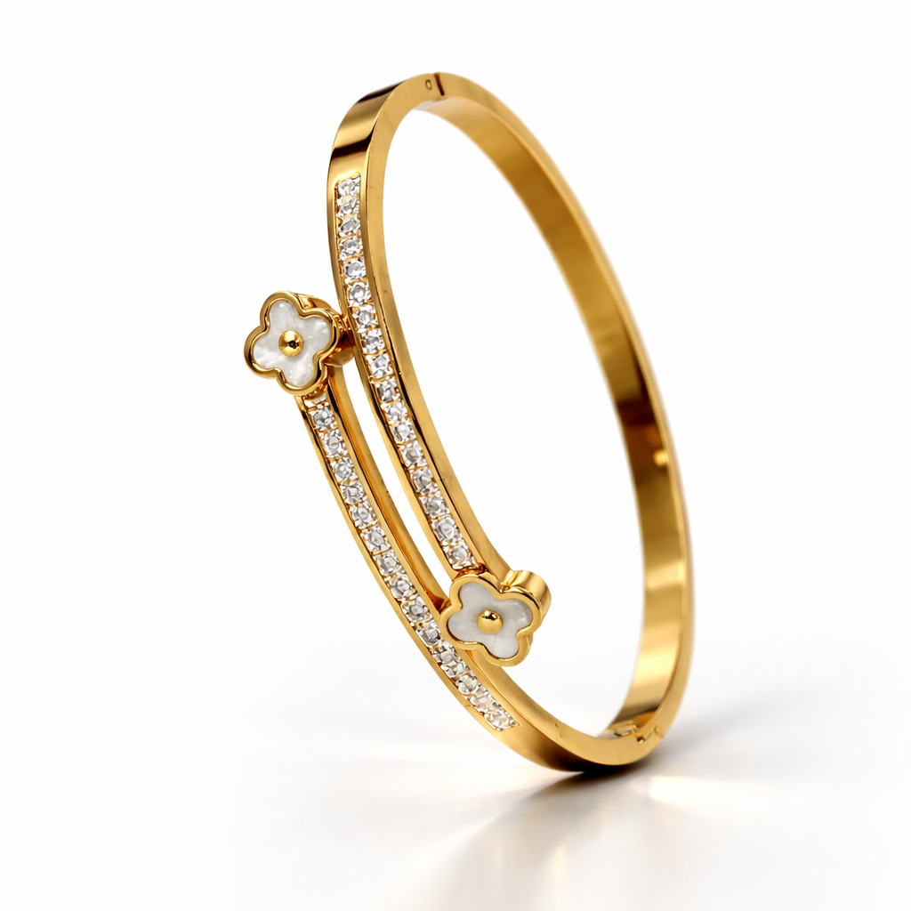 Gold bracelet with floral designs on a white background