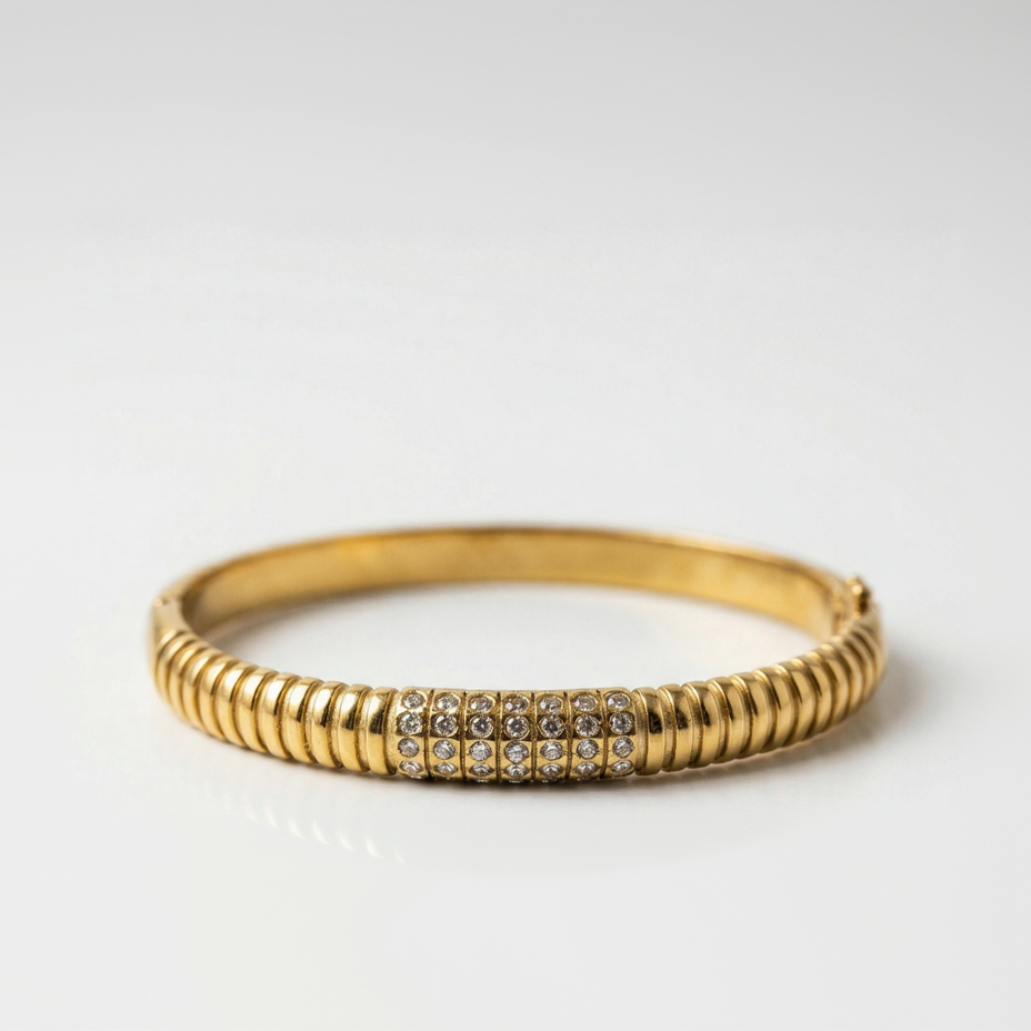 Gold bracelet with rhinestones on a white background