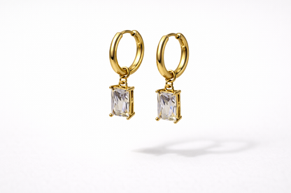 Gold hoop earrings with rectangular gemstones on a white background