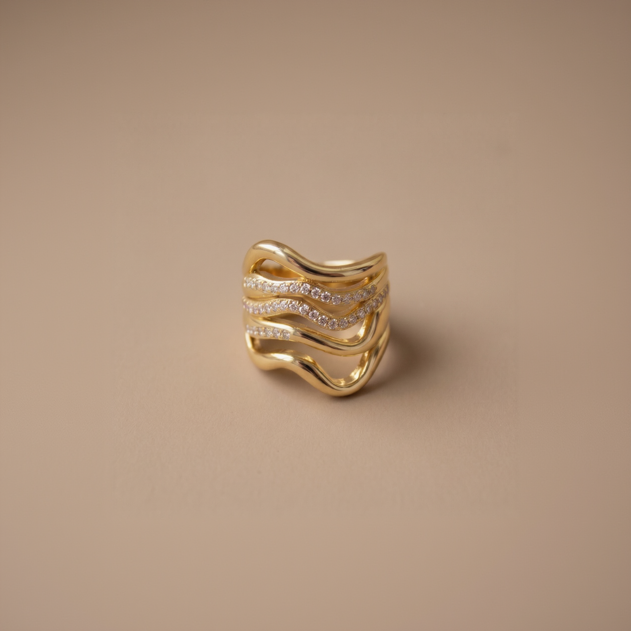 Gold ring with diamond accents on a beige background