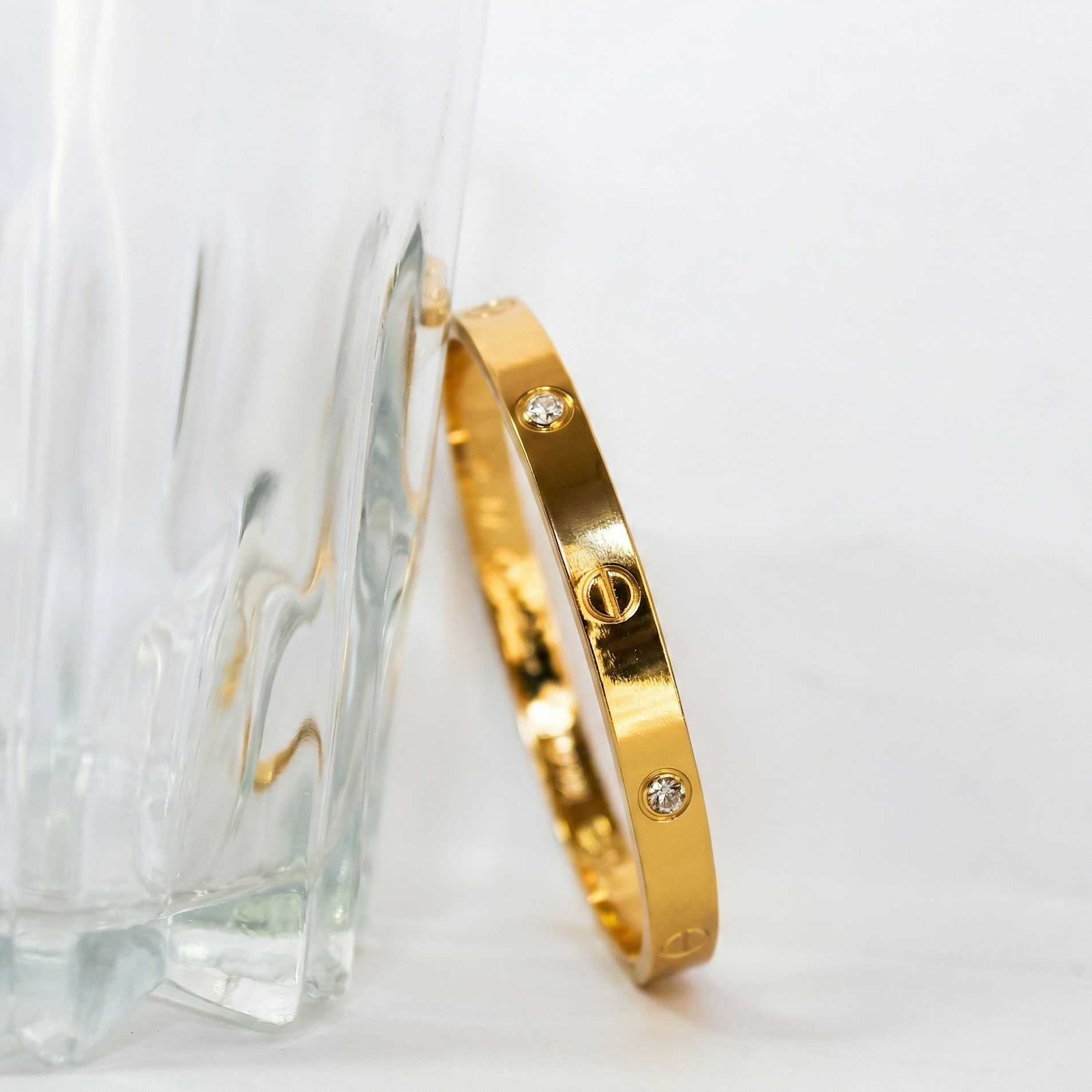 Gold ring with diamond accents on a white background