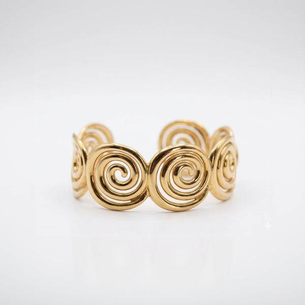 Gold spiral bracelet on a white background