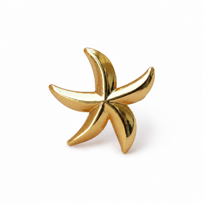 Gold starfish-shaped earring on a white background
