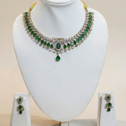 Green gemstone necklace and earrings on a white mannequin bust with a beige background