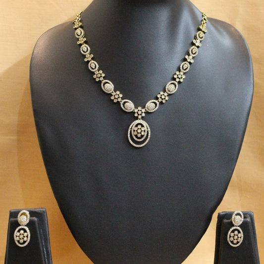 Gold necklace on a black mannequin bust against a beige background