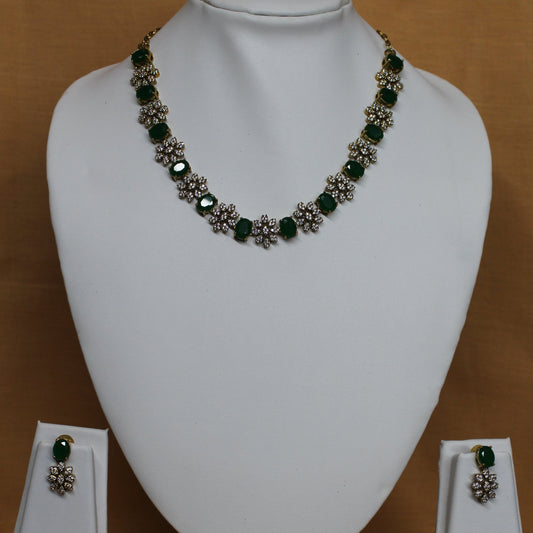 Jewelry set including a necklace, earrings, and ring on a white mannequin bust against a brown background.