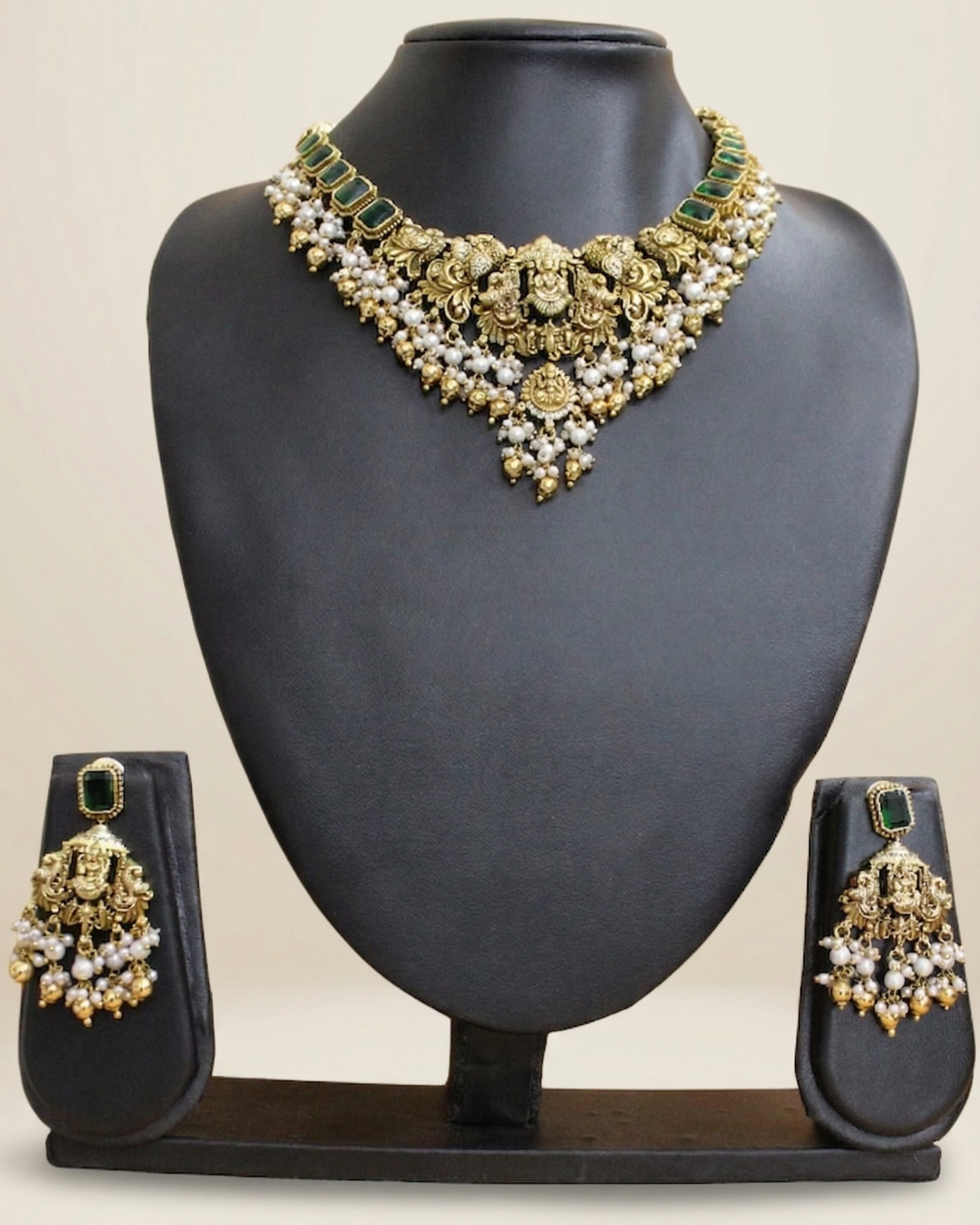 Jewelry set with necklace and earrings on a black mannequin bust.