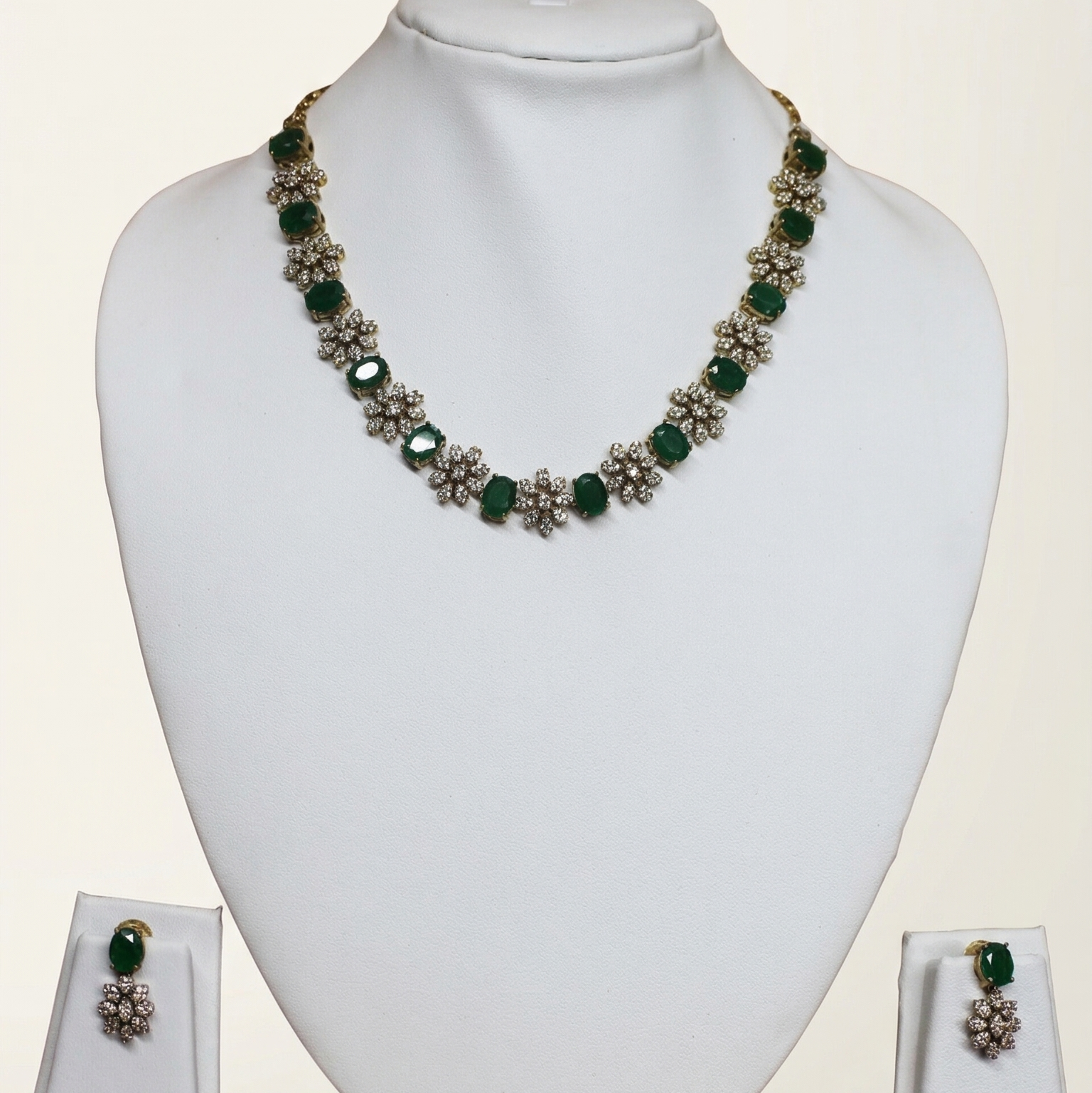 Jewelry set with necklace and earrings on a white mannequin bust