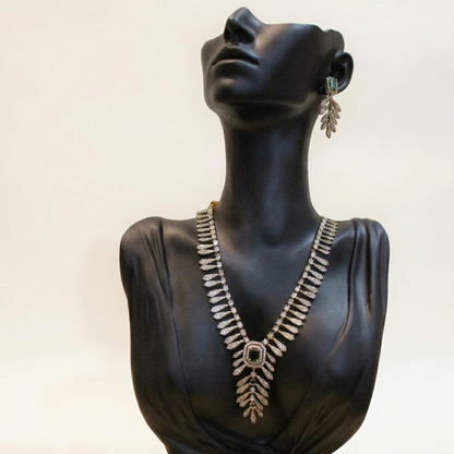 Mannequin bust wearing a necklace and earrings on a white background