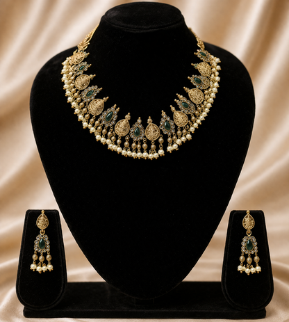 Jewelry set with necklace and earrings on a black stand against a beige background