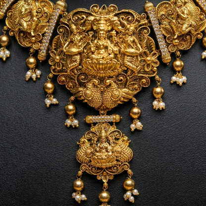 Gold necklace with intricate design on a dark background